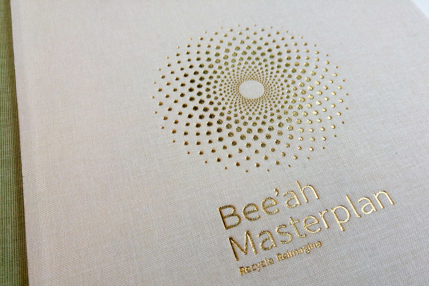 Detail of Bee'ah report covers with deboss and foil logo